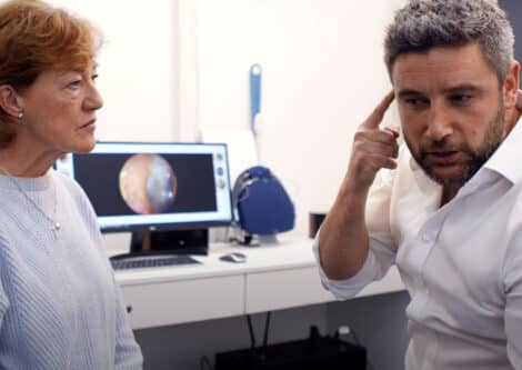 Matt Cannon discussing hearing aid options with a patient